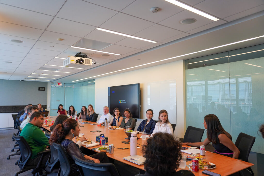 Large group of people sitting at conference table