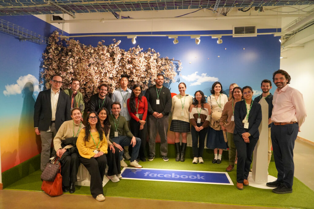Large group of people posing next to faux cherry blossom tree