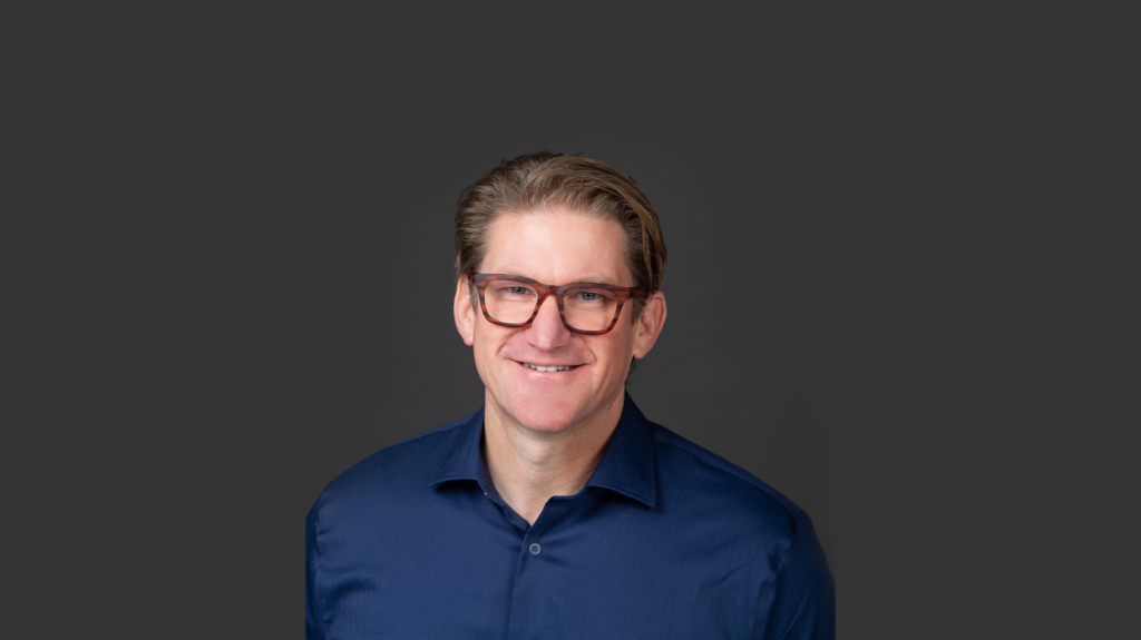 Wade Swenson headshot against dark background
