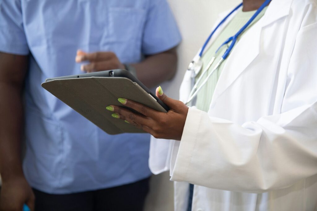 A doctor showing a patient something on a tablet
