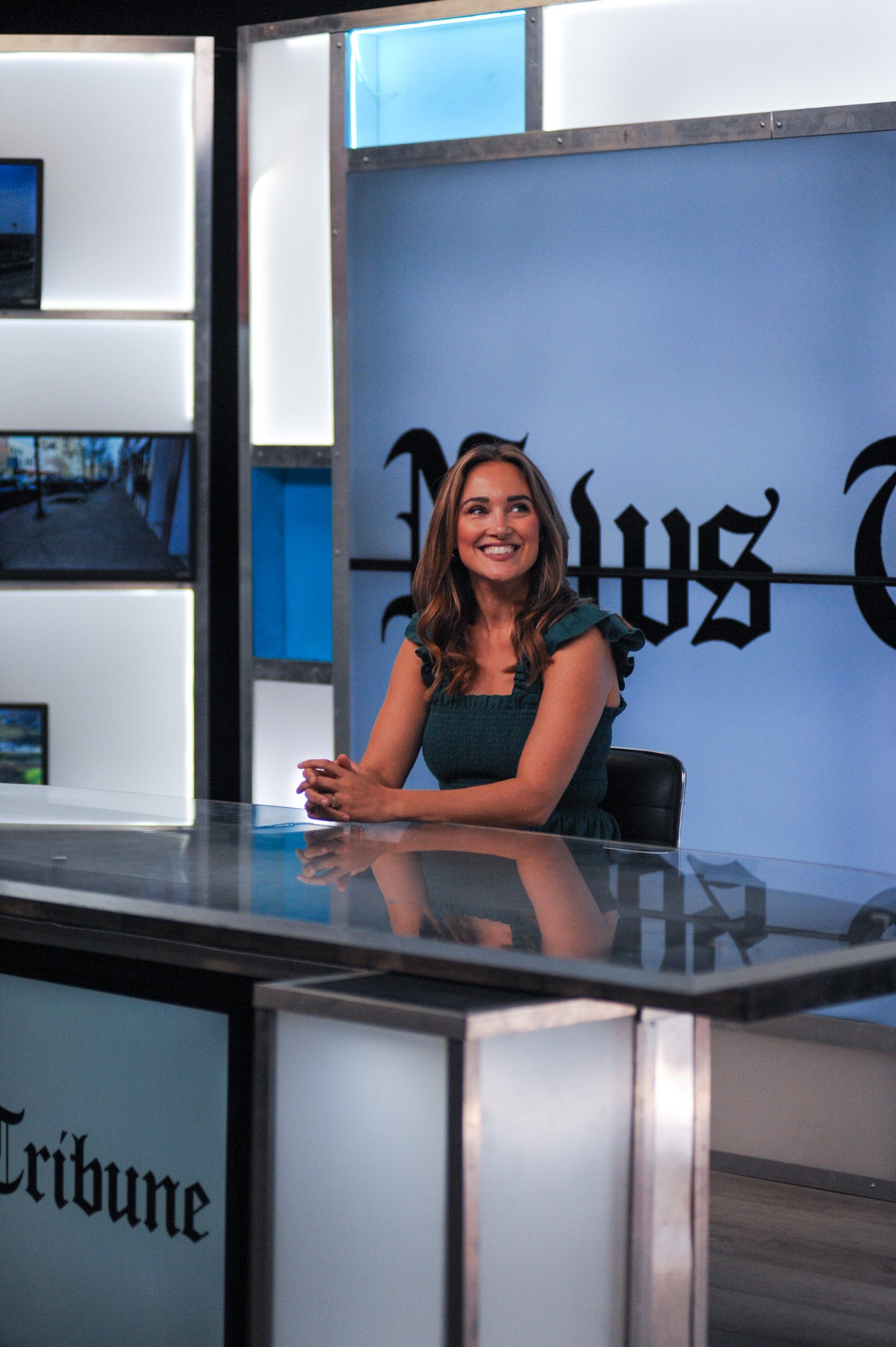 Erin Shrimpf sitting at news anchor desk