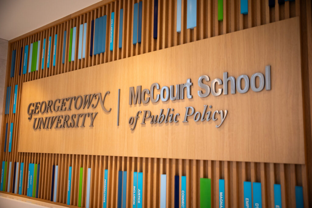 Signage for McCourt School on wooden wall
