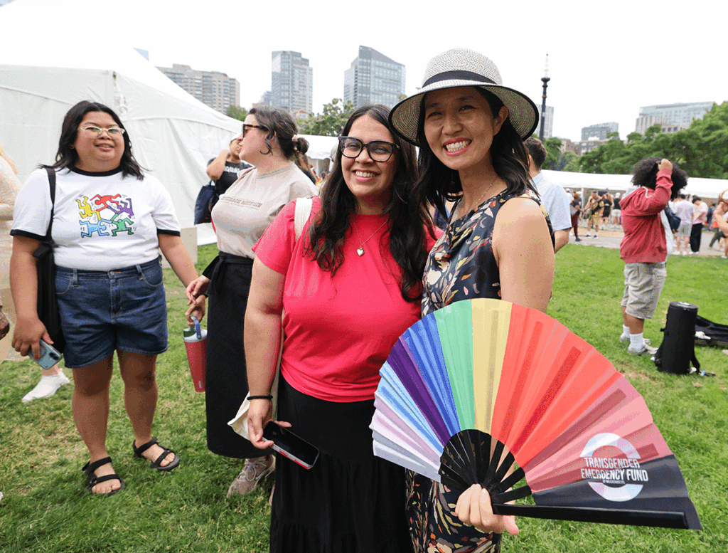Tejas and a friend holding rainbow handfan