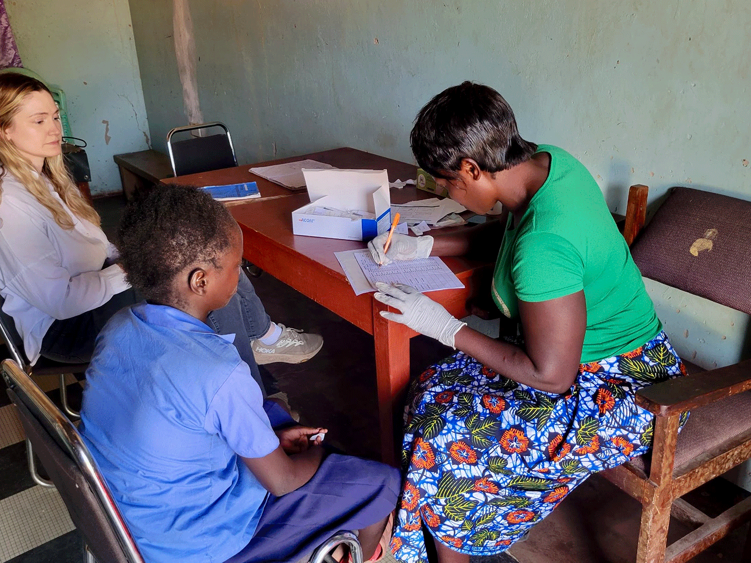 Fieldworker takes notes in Zambian school