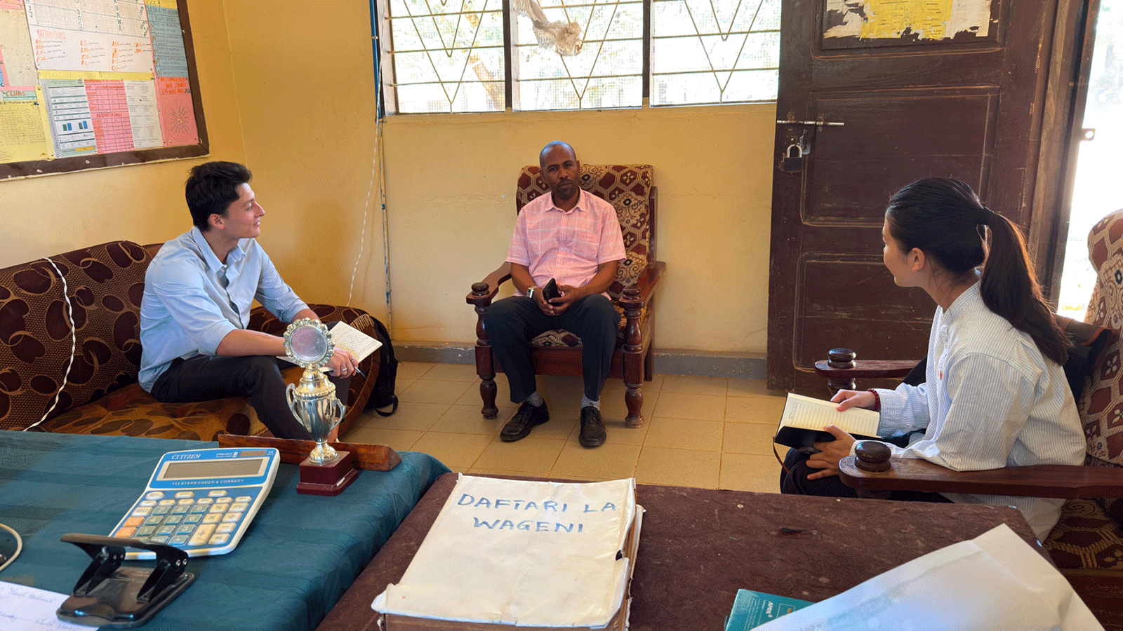 Xia interviewing school's head teacher in Tanzania