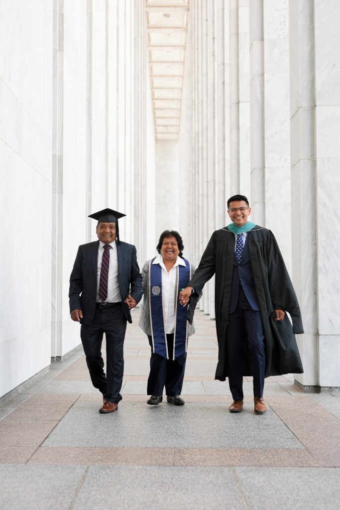 Eduardo Ramos (MPM'26) walks with his parents, holding hands, in the National Mall.