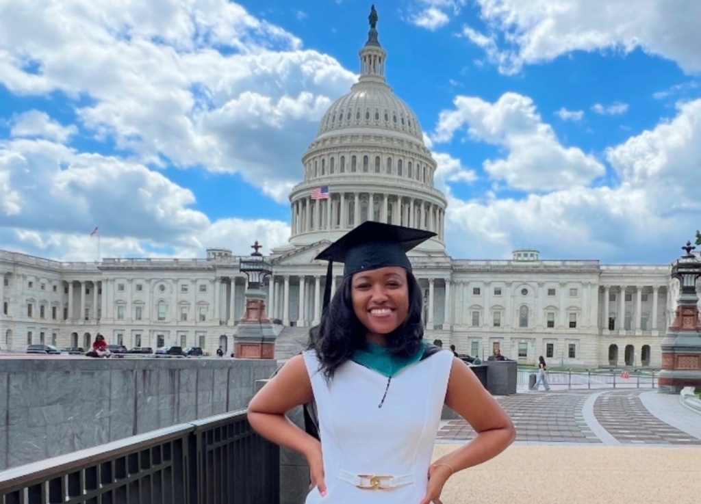 Alum Kaitlin Johnstone stands in front of the U.S. Capitol.