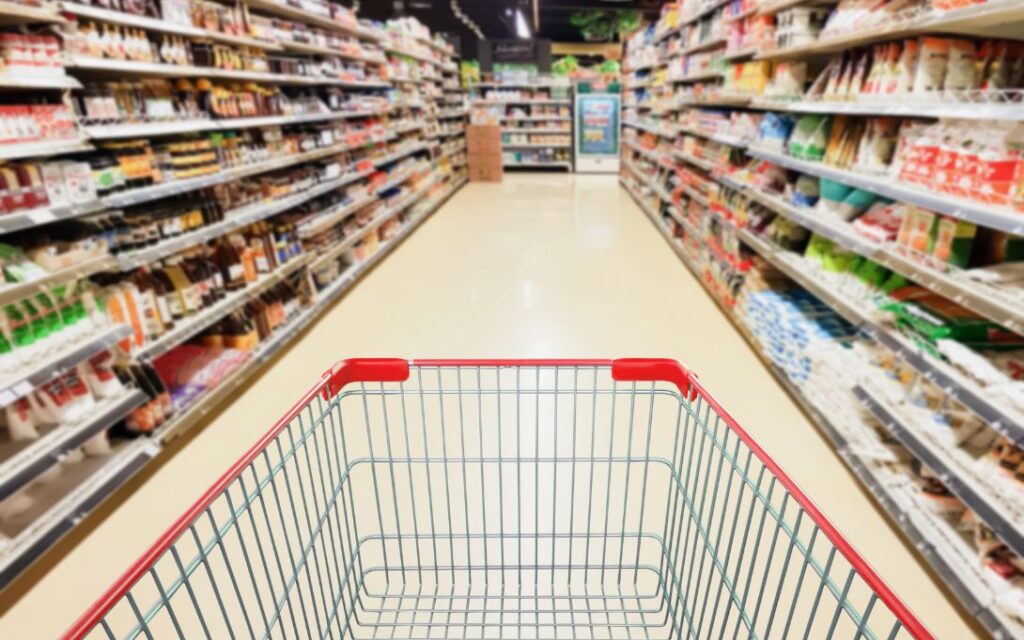 Grocery cart image in a grocery store aisle.