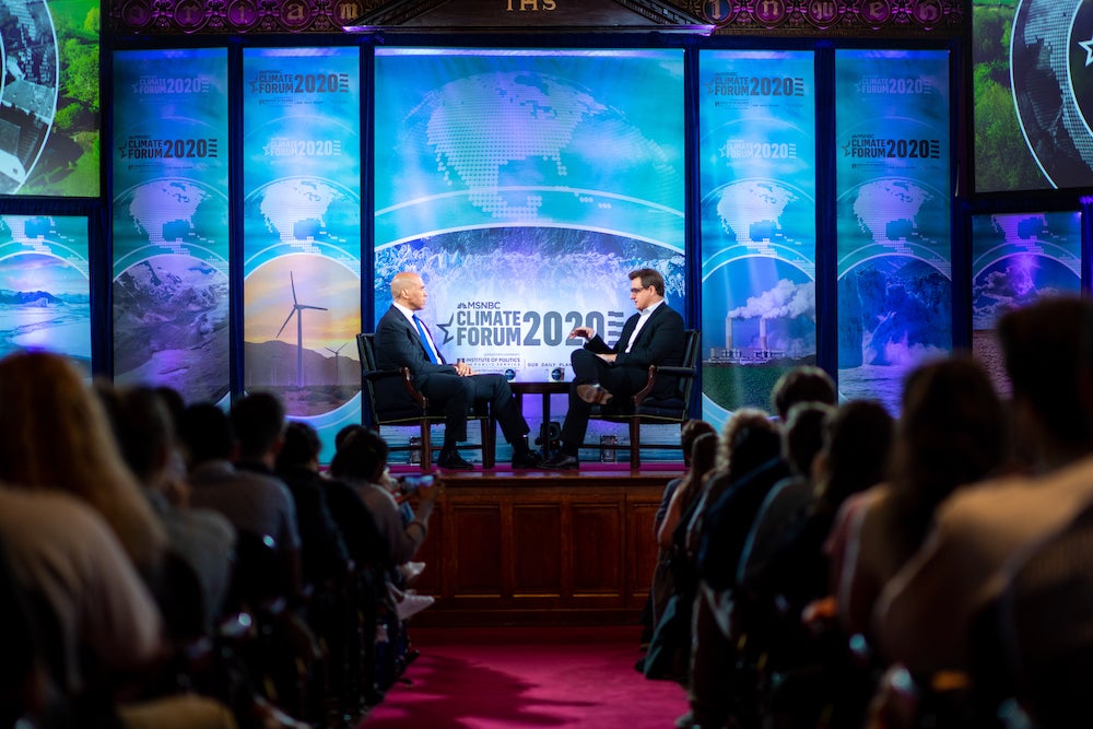 Chris Hayes interviews Cory Booker on stage.